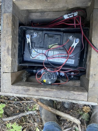 Off-site water trough using a solar panel, pump and battery to keep full.